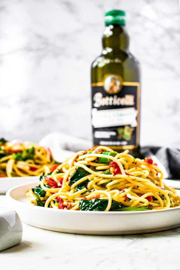 Spaghetti Aglio e Olio is a classic Italian recipe consisting of spaghetti tossed in a garlic infused olive oil pasta sauce, sometimes with red pepper flakes for a pinch of spicy. This veggie-loaded version is easy to make and full of healthy vegetables like broccoli rabe, roasted red peppers, and sun-dried tomatoes. This classically vegan and vegetarian dish comes together in under 30 minutes and is the perfect recipe for date night or a dinner party.