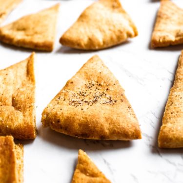 Make your own pita chips in the air fryer with just 4 ingredients and 20 minutes of your time! Perfect for snacking or dipping in hummus. #vegan #veganrecipe #airfryer #airfryerrecipes #pitachips #easyveganrecipes #vegansnack #homemade