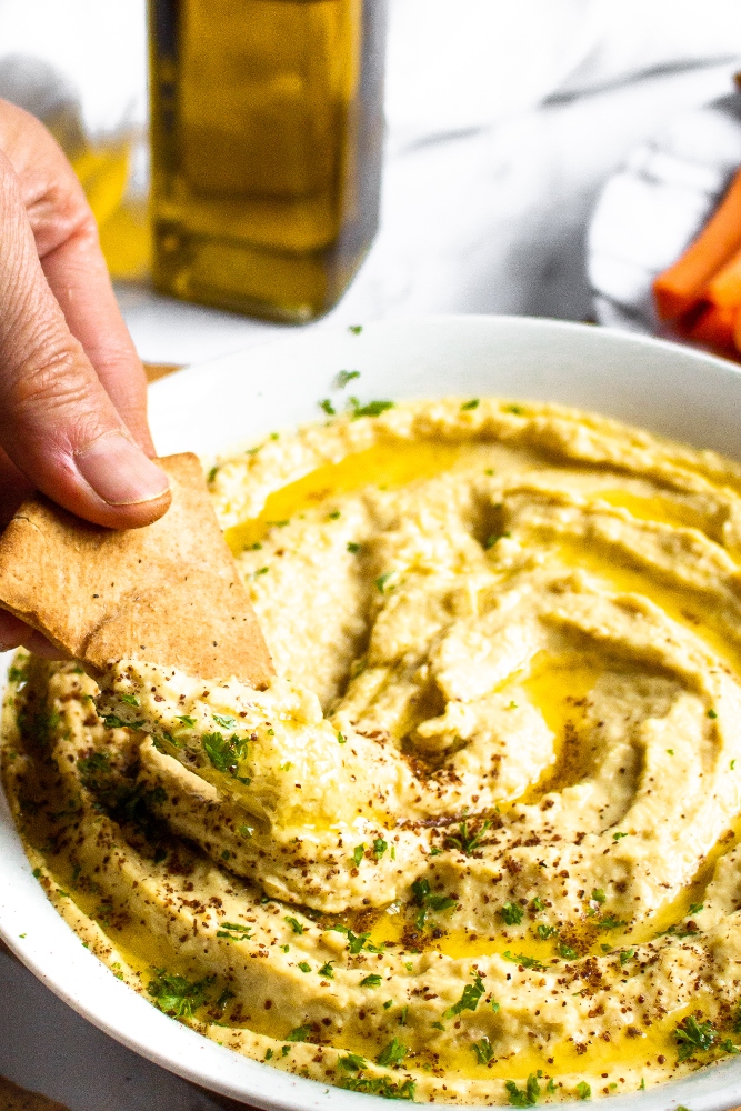 Make your own pita chips in the air fryer with just 4 ingredients and 20 minutes of your time! Perfect for snacking or dipping in hummus. #vegan #veganrecipe #airfryer #airfryerrecipes #pitachips #easyveganrecipes #vegansnack #homemade
