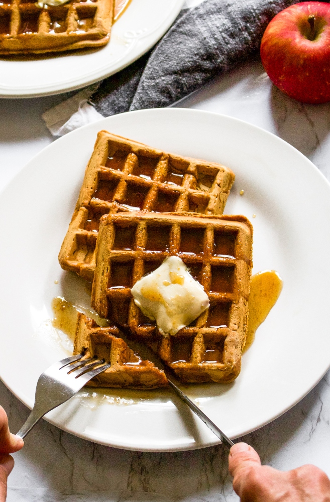 These vegan apple cider waffles with ginger snap syrup are a fun fall breakfast recipe without any butter, milk, or eggs! It’s an easy way to use up extra apple cider and apple sauce. Plus, they can even be made into apple cider pancakes if you don’t have a waffle maker. Store them in the freezer and reheat them in the toaster for easy comfort food breakfast or snack on the go. #applecider #applerecipe #waffles #veganwaffles #fallbreakfast #veganbreakfast #dairyfreebreakfast