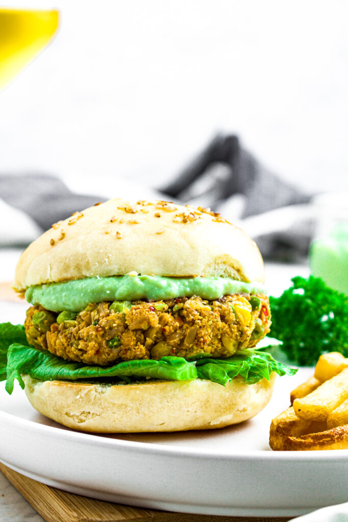Close up head on photo of a copycat dr prager's burger on a bun with avocado