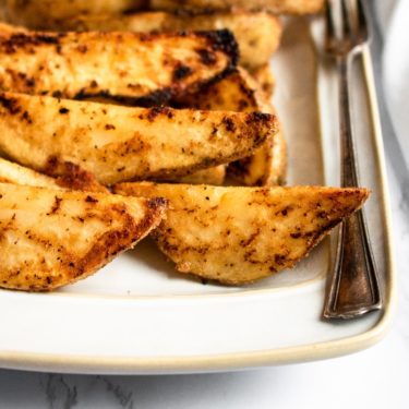 These cast iron potato wedges recipe is easy to make, super dependable, and can be altered to your specific spice/flavor desires. A healthier alternative to french fries, they’re great paired with ALL your summer grilling favorites or just as a snack served with ALL the dips! #vegan #potatoes #potatowedges #plantbased #castiron #comfortfood #veganrecipe
