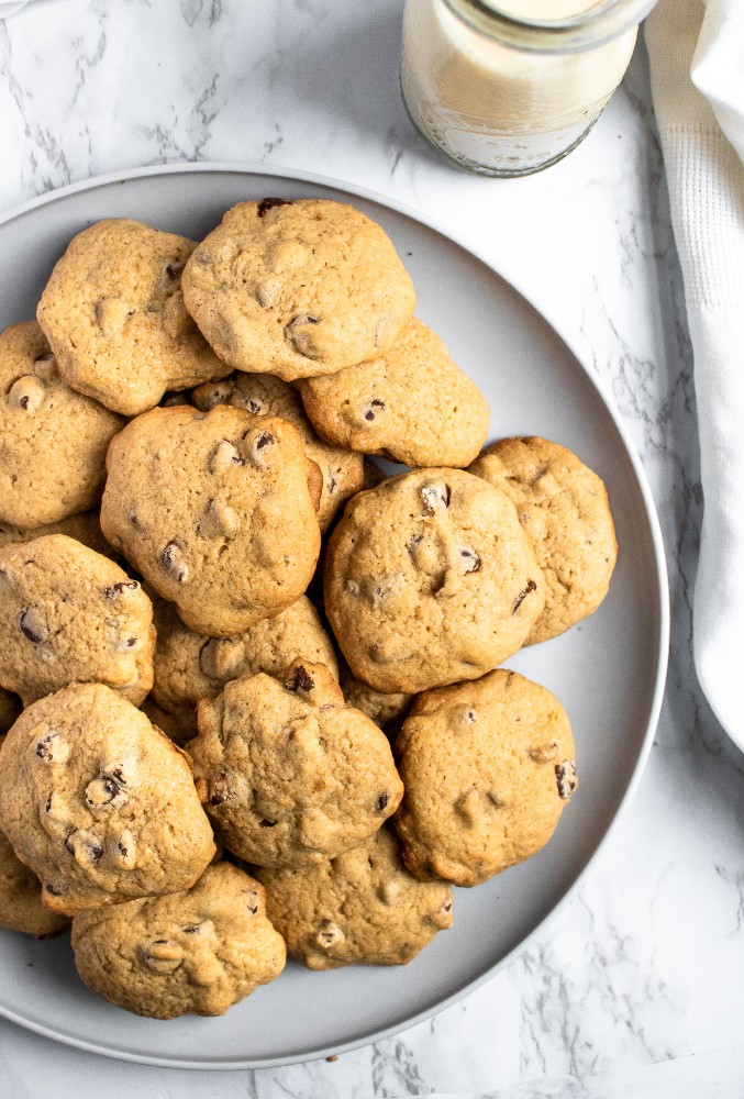 These are the BEST vegan chocolate chip cookies. The recipe is easy to make with simple ingredients, using applesauce instead of eggs for a healthy swap. These chewy vegan cookies taste just like the ones you grew up making! #vegan #vegancookies #vegandessert #vegandessertrecipe #chocolatechipcookies #eggfree #dairyfree #chocolate #veganchocolate #vegan #veganbaking #holidaybaking