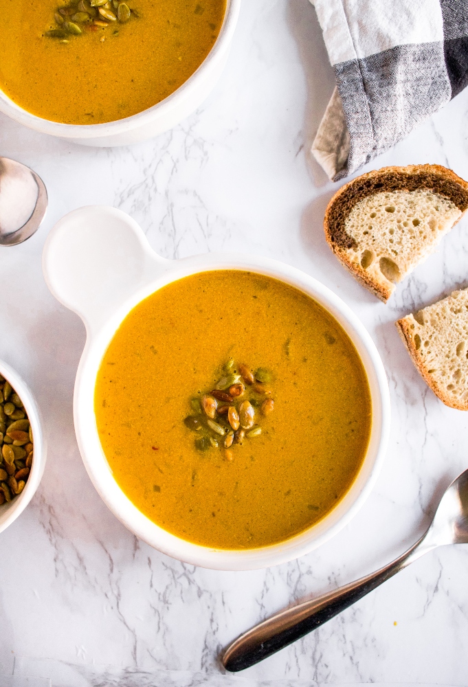 This savory curried pumpkin soup is an easy one-pot plant-based meal. Make it on the stove or in the slow-cooker with either canned pumpkin or fresh pumpkin and a few kitchen staples. It’s gluten-free, dairy-free (without coconut milk!), and includes an oil-free option. #vegan #pumpkinsoup #savorypumpkinrecipe