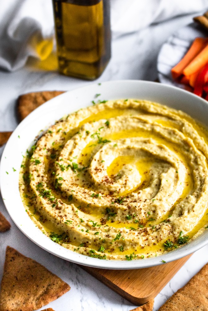 This Extra Garlic Hummus (emphasis on the “EXTRA”) is the perfect snack or appetizer for all our fellow garlic lovers out there! It’s an easy-to-make 10-ingredient dip with a dynamite flavor and silky smooth texture that will not disappoint. #vegan #vegansnack #veganappetizer #plantbased #hummus #hummusrecipe #garlic #garlicrecipe