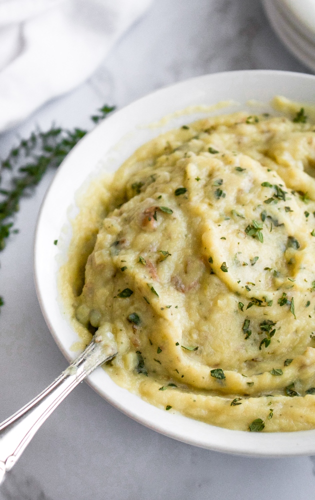These Dairy Free Roasted Garlic Mashed Potatoes are a healthy vegan mashed potato recipe packed with flavor. They are a great plant-based holiday side dish or cozy everyday dinner side. Instead of butter, they use a creamy roasted garlic sauce made with silken tofu that adds extra protein without a ton of fat!