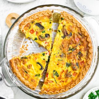 Overhead photo of a sliced vegan quiche in a dairy-free pie crust