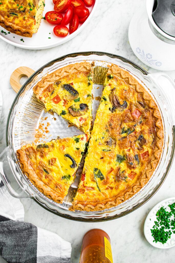 Overhead photo of a sliced vegan quiche in a dairy-free pie crust