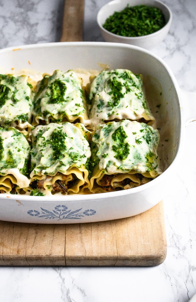 Vegan White Mushroom Lasagna Rolls with meaty sauteed mushrooms, flavor-packed pesto, smoky walnut sausage, and a dreamy roasted garlic sauce. They can be made ahead of time and are perfect for date-night-in! #vegan #mushrooms #lasagna #veganlasagna #plantpowercouple #pesto #walnuts #tofu #pasta #veganpasta // plantpowercouple.com