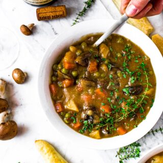 This hearty, vegan mushroom stew recipe is easy to make and sure to please! Packed with root vegetables, earthy herbs, and meaty mushrooms swimming in a thick, velvety broth, this may quickly become your new favorite vegetarian winter dinner!