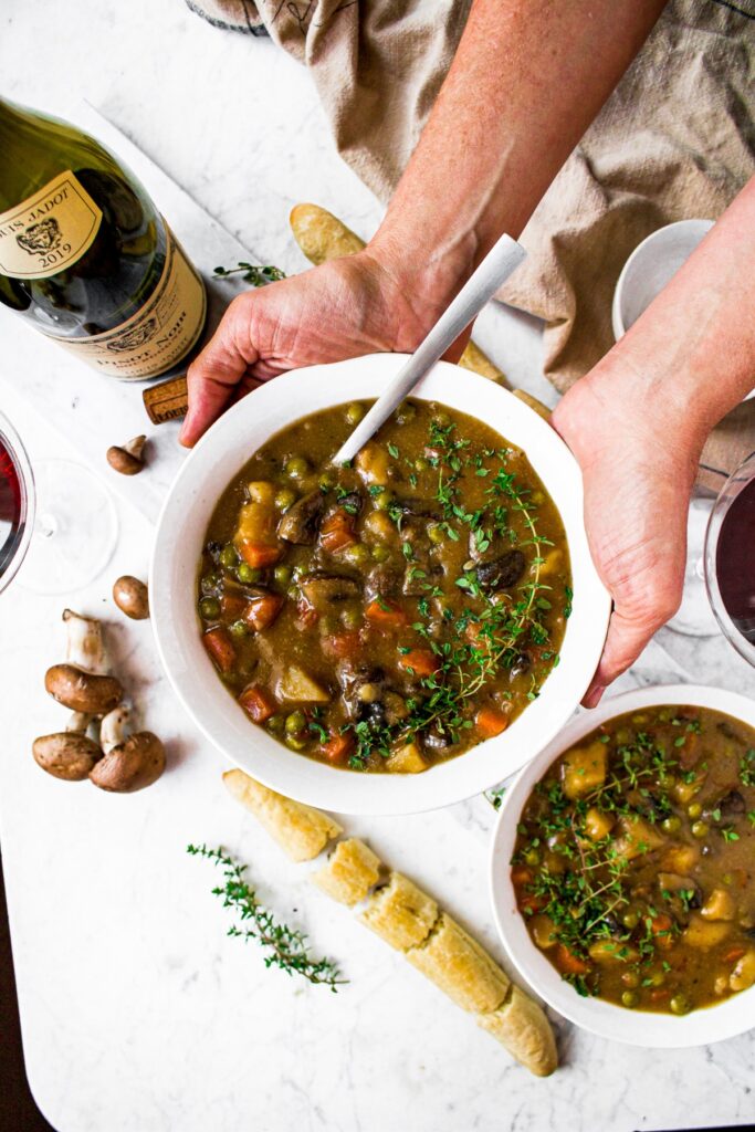 This hearty, vegan mushroom stew recipe is easy to make and sure to please! Packed with root vegetables, earthy herbs, and meaty mushrooms swimming in a thick, velvety broth, this may quickly become your new favorite vegetarian winter dinner!