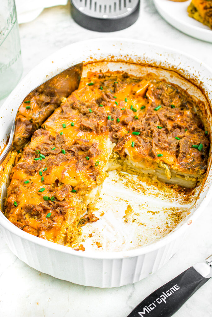 Close up overhead photo of a vegan breakfast potato bake with a large slice taken out