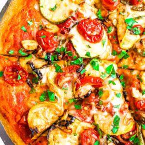 Overhead close up view of half a roasted balsamic vegetable pizza