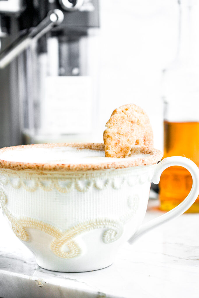 Head on view of a white mug rimmed with cinnamon