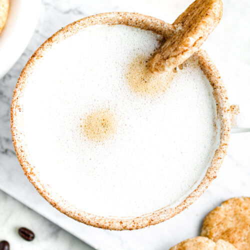 Close up overhead view of a vegan snickerdoodle latte in a large white mug