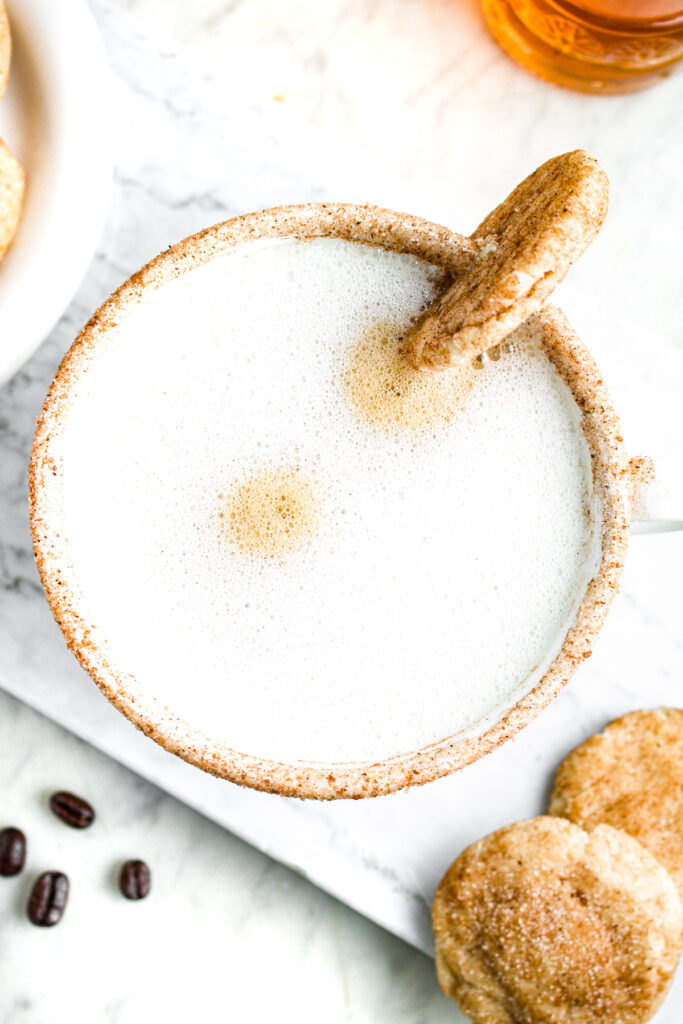 Close up overhead view of a vegan snickerdoodle latte in a large white mug