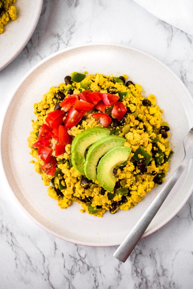 This vegan tofu scramble recipe infused with Southwest flavors is a healthy and delicious plant-based breakfast option! It’s an egg-free breakfast scramble made with black salt for that unique eggy flavor as well as a wonderful array of common household spices. We love to serve this as a breakfast platter or burrito and even sometimes make a big batch to have breakfast for dinner!