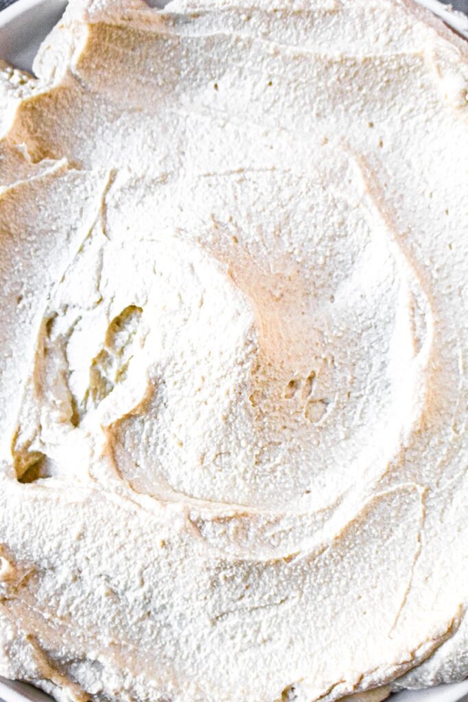 Close up overhead shot of a creamy vegan tofu ricotta cheese spread in a thick circular pattern