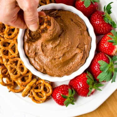 If you’re looking for an easy Valentine’s Day dessert you can whip up in under 10 minutes but is still sure to impress and make you feel indulgent, we have the recipe for you! This Vegan Brownie Batter Dip is our favorite tahini-based dessert dip. Serve it on a platter with pretzels and strawberries for date night or any time you really want a wow-factor! This is an amazing (ps: it’s also healthy) tahini dessert, and if you’ve never tried tahini in a dessert before, get ready for your life to change.