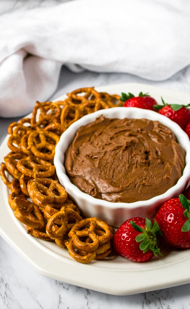 If you’re looking for an easy Valentine’s Day dessert you can whip up in under 10 minutes but is still sure to impress and make you feel indulgent, we have the recipe for you! This Vegan Brownie Batter Dip is our favorite tahini-based dessert dip. Serve it on a platter with pretzels and strawberries for date night or any time you really want a wow-factor! This is an amazing (ps: it’s also healthy) tahini dessert, and if you’ve never tried tahini in a dessert before, get ready for your life to change.