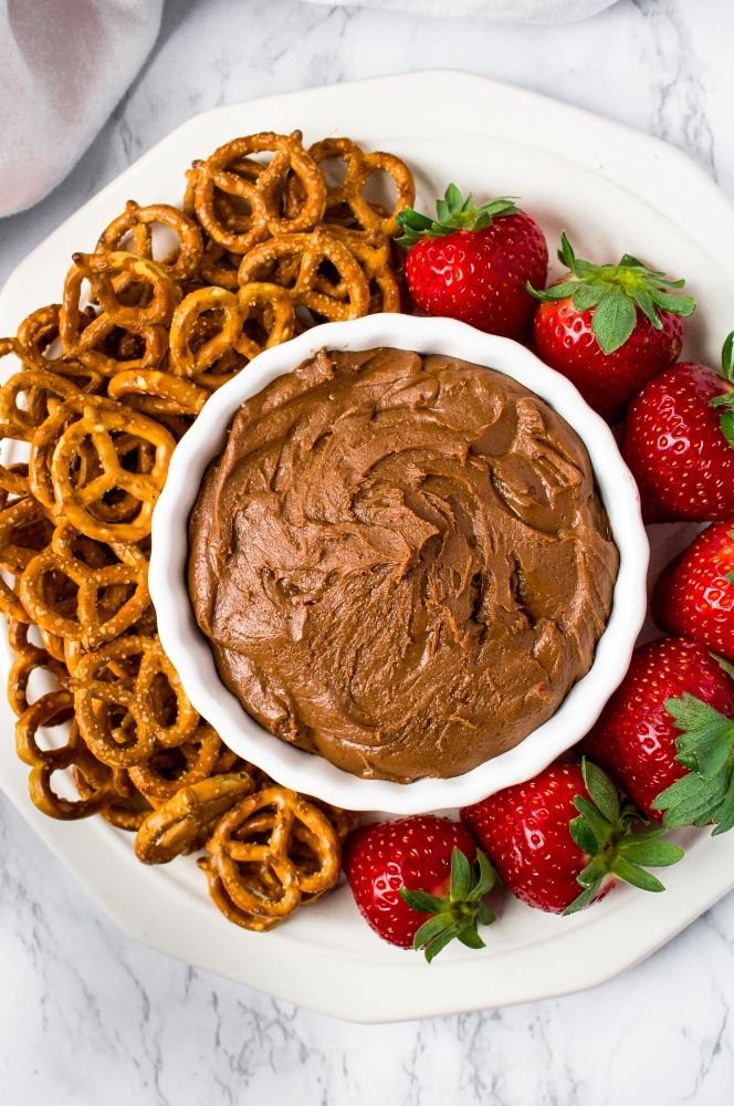 If you’re looking for an easy Valentine’s Day dessert you can whip up in under 10 minutes but is still sure to impress and make you feel indulgent, we have the recipe for you! This Vegan Brownie Batter Dip is our favorite tahini-based dessert dip. Serve it on a platter with pretzels and strawberries for date night or any time you really want a wow-factor! This is an amazing (ps: it’s also healthy) tahini dessert, and if you’ve never tried tahini in a dessert before, get ready for your life to change.