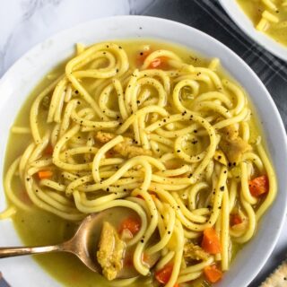 This vegan chicken noodle soup is the stuff of our childhood sick day dreams! Warm + cozy broth bursting with flavor, thick brothy noodles, tender chicken-free chicken. Easy, soothing, gluten-free option. #vegan #soup #plantbased #veganrecipe // plantpowercouple.com