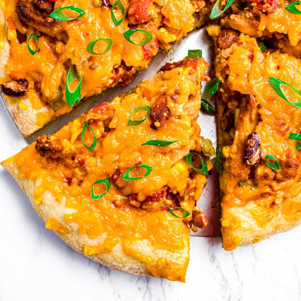 Overhead view of a slice of vegan chili cheese pizza