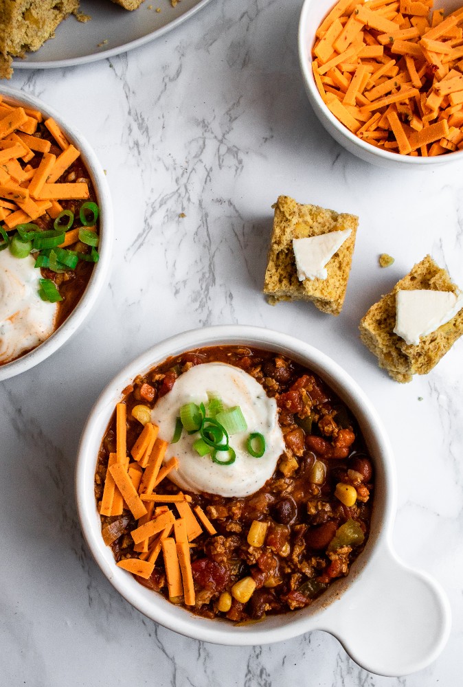 Simple vegan chili recipe, made with TVP, is warm and cozy like a bowl full of hugs! It’s a super easy and hands-off recipe that is perfect for meal prep or a busy weeknight dinner. Add everything to one pot and let it simmer. #vegan #veganchili #chili #plantbased // plantpowercouple.com