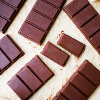Overhead shot of homemade chocolate bars, some broken into rectangular pieces.
