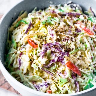 Head on photo of a large mixing bowl filled with plant-based coleslaw