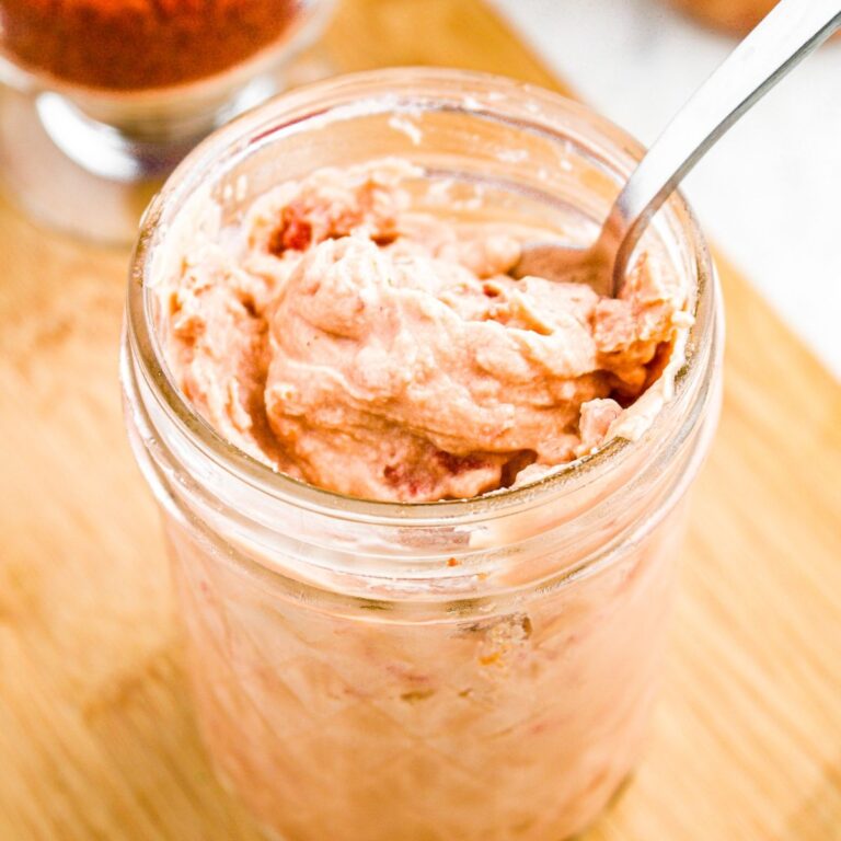 Overhead photo of a jar of cream of bacon soup substitute with a spoon digging into it