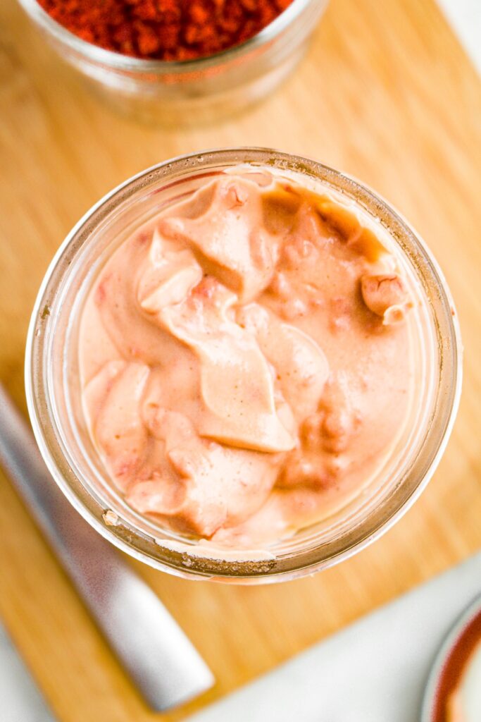 Overhead close up photo of an open jar of vegan cream of bacon soup