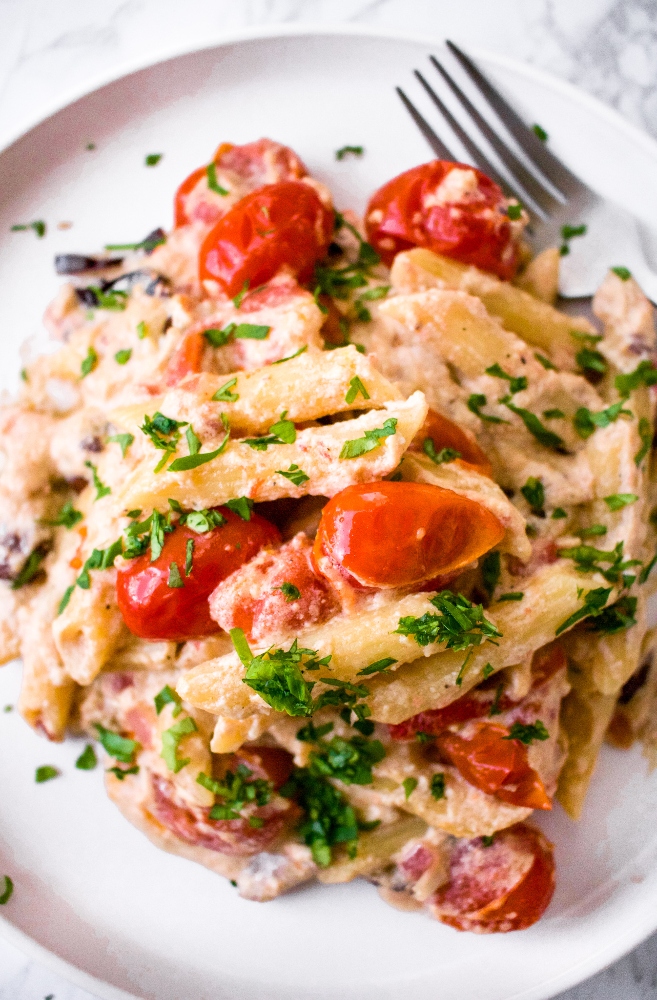 This Vegan Baked Feta Pasta is a Mediterranean-inspired, veganized version of the viral TikTok pasta recipe made famous by Finnish food blogger Jenni Häyrinen. In our version, we take it to the next level with flavors like tahini, kalamata olives, and roasted red peppers. Made with a luxurious homemade vegan feta cheese sauce, this recipe is not only a cheaper version than using store-bought vegan feta cheese, but it’s healthier and allergy-friendly too
