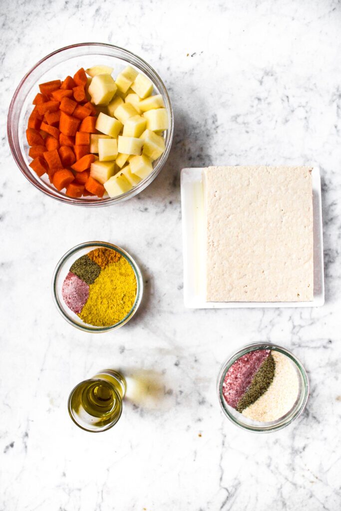 Overhead photo of all the ingredients you need to make a vegan fried egg out of tofu and a potato carrot yolk sauce