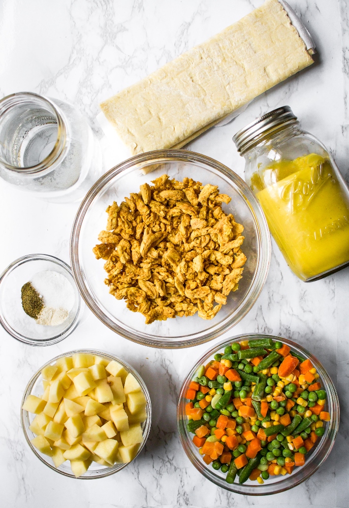 This vegan pot pie casserole is a quick and deliciously dairy-free and vegetarian version of the savory chicken pie I fell in love with in London. It’s made with tremendously simple and easily found ingredients like store-bought puff pastry and frozen mixed vegetables. The hardest part of this vegan chicken pot pie recipe is waiting for it to finish cooking!