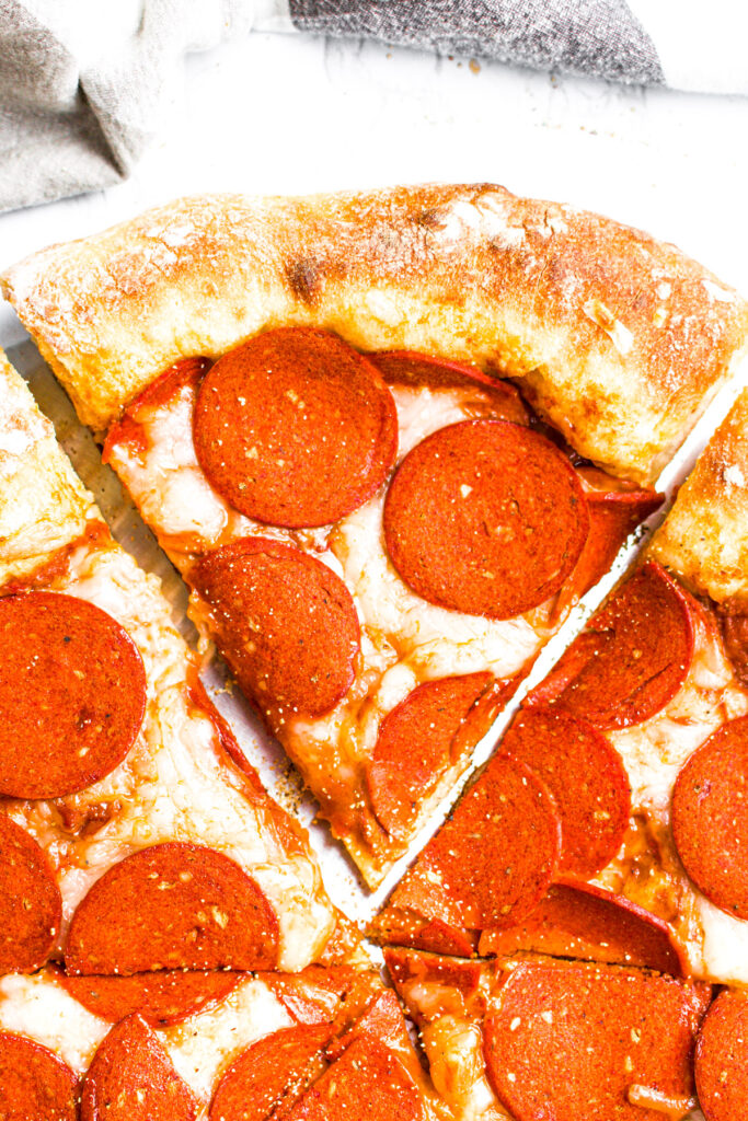 Overhead view of a slice of dairy-free stuffed crust pizza with veggie pepperoni