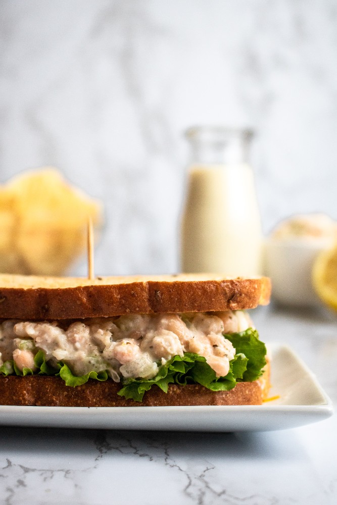 This vegan tuna salad is a simple recipe, using white beans and a few other common ingredients you probably have around the house + one *magic* ingredient to create the flavor + texture of a classic tuna sandwich! #vegan #tuna #vegantuna #lunch #veganlunch #beans #plantbased #navybeans #whitebeans