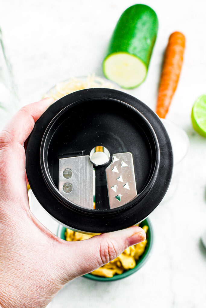 overhead photo of a hand holding a Microplane spiralizer